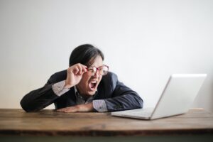 yelling formal man watching news on laptop